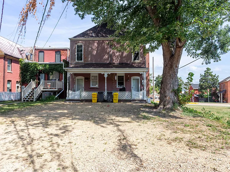 Back of property with porch & off street parking