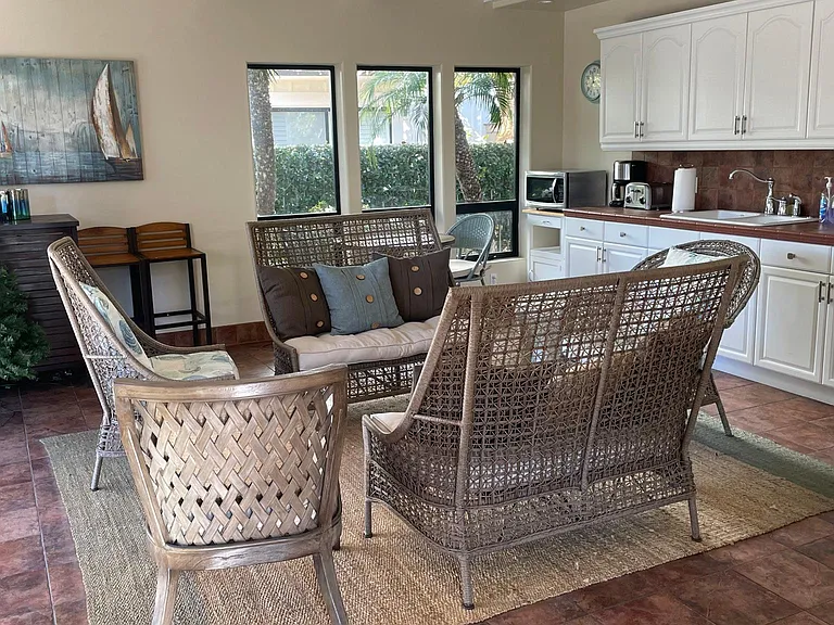 Pool club house available for social gatherings offering a small kitchen and bathroom.