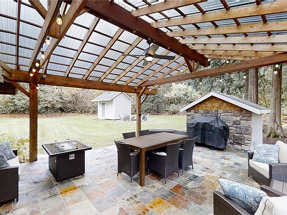 Covered Patio with Slate Decking and Ceiling Fan Perfect for Outdoor Entertaining