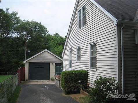 One car garage is larger than it looks and opens to a workshop and storage in the back.
