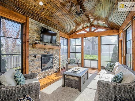 Unbelievable enclosed porch with insulated roof, EZ Breeze windows, and fireplace with remote and blower.