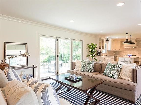 Living area is open to Kitchen --La Cantina door system opens to porch and huge back yard