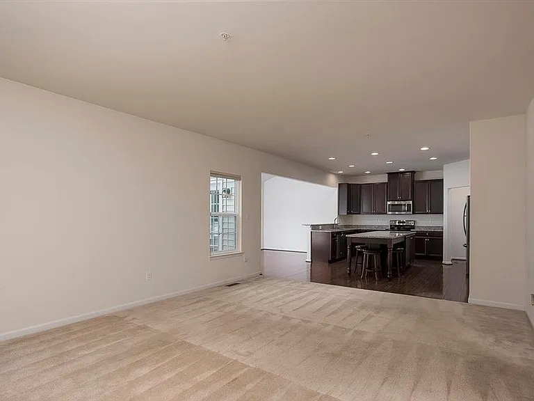 Main living room looking to kitchen and dining room