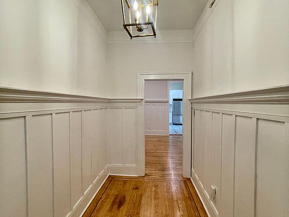 Entry way of unit, looking into living room and kitchen in the distance