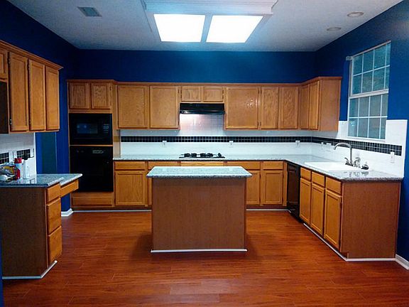 SPACIOUS KITCHEN WITH UPDATED GRANITE COUNTERTOPS, FLOORING. THE ISLAND IS A GREAT WORKSPACE FOR THE