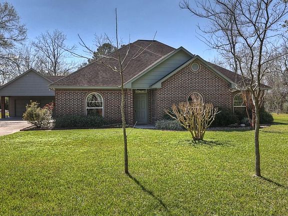 Front view of the home is partially secluded from Hufsmith Rd.