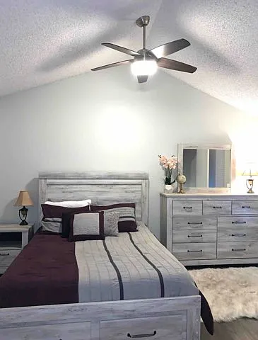 Upstairs bedroom (includes: queen-size bed with storage underneath, dresser with mirror, nightstand, and another dresser off camera)
