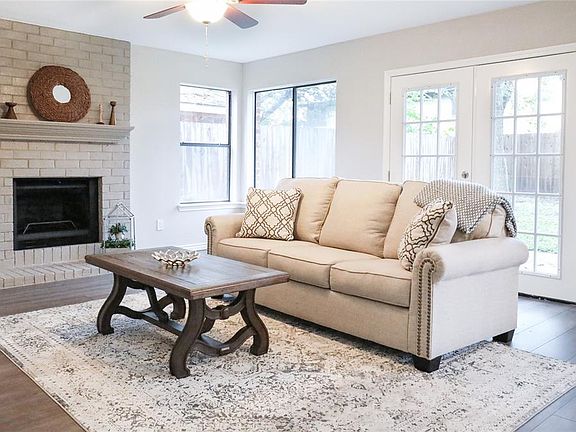 Very cozy den with it's own fireplace and double doors to the backyard.