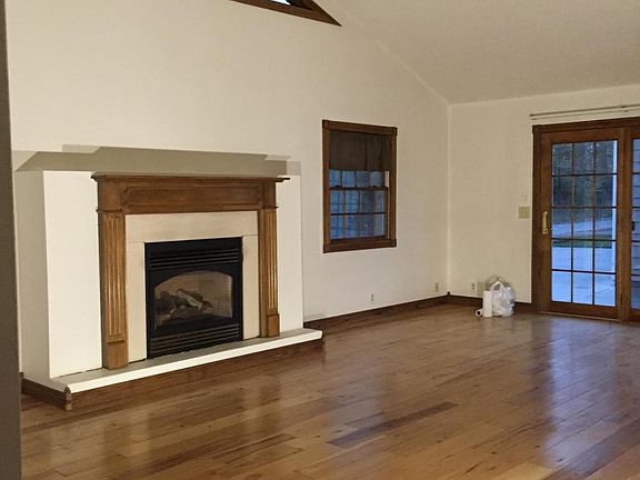 great room with vaulted ceiling, hardwood floor, gas firepla