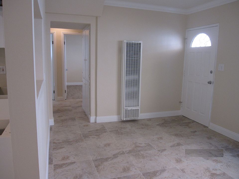 Living area with crown molding and Italian ceramic tiles