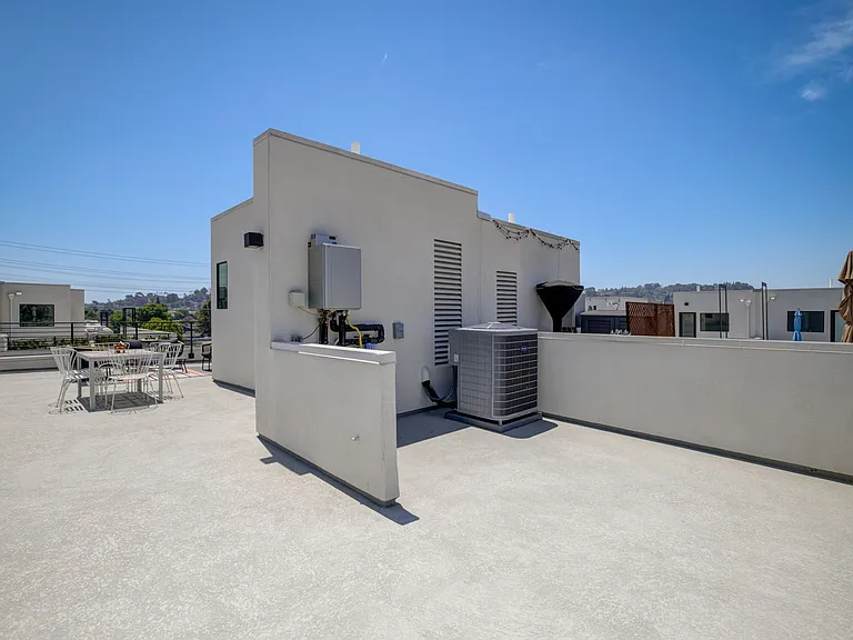 Expansive rooftop deck with mountain views, perfect for entertaining, outdoor dining, and relaxing.