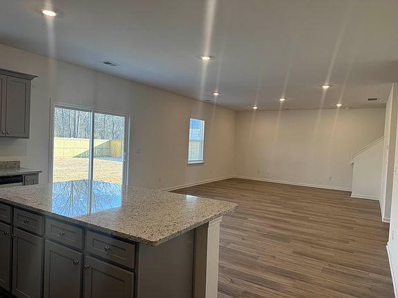 Modern family room filled with natural light, offering beautiful views and easy access to the large private backyard.