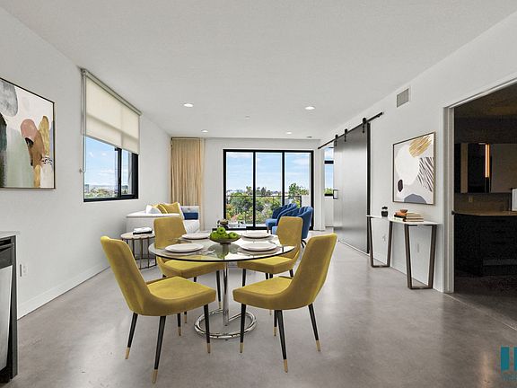 Open-Concept Dining and Living Room Area with Bathroom and Patio