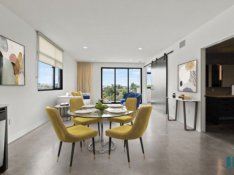 Open-Concept Dining and Living Room Area with Bathroom and Patio