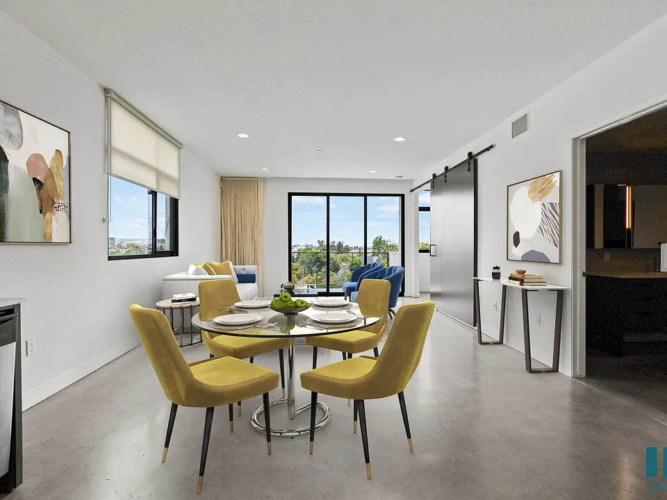 Open-Concept Dining and Living Room Area with Bathroom and Patio
