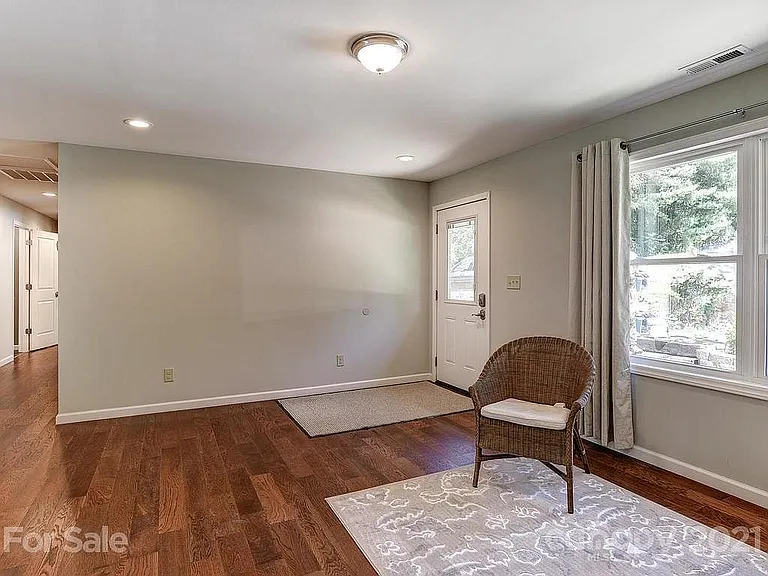 Living area. View of the front door.