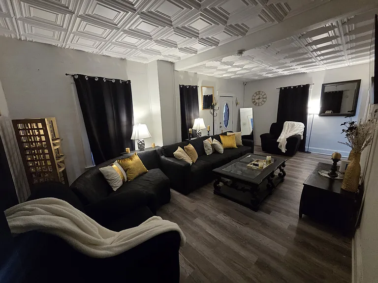 Comfortable shared living room with seating and TV, providing a relaxing space for residents to unwind and socialize.