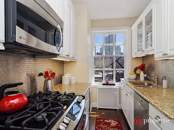 Crisp white kitchen with southern urban views