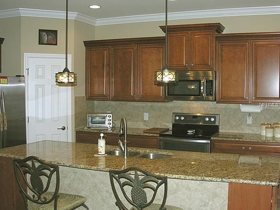 Gorgeous kitchen with closet pantry, wood cabinets and granite counters.