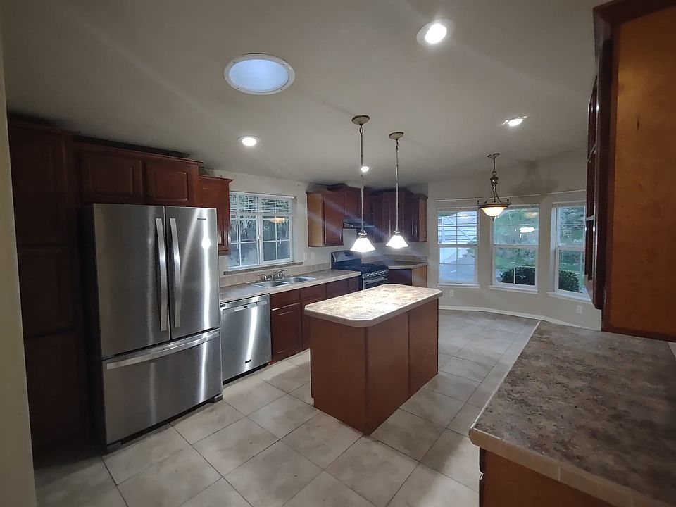 Kitchen with stainless steel fridge and dishwasher