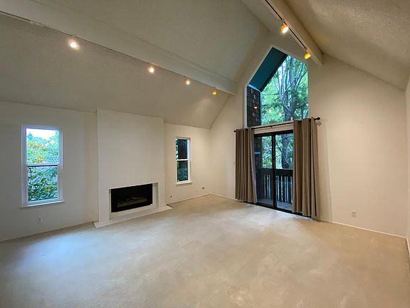 Living room with gas fireplace and small balcony.