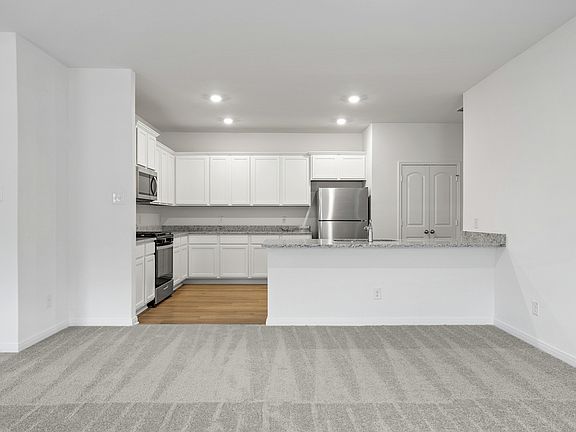 The spacious kitchen with beautiful white cabinets and granite countertops!