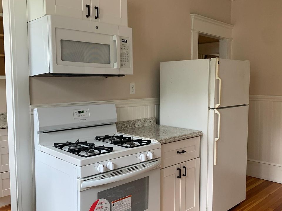 Newly renovated kitchen with hardwood floors, pantry area with dishwasher.