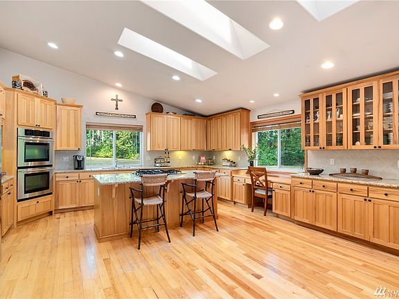 Bright & open kitchen with hickory cabinets and built-in desk overlooking the yard.