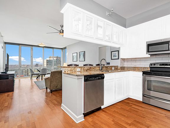 The kitchen cabinets are currently wood colored bu