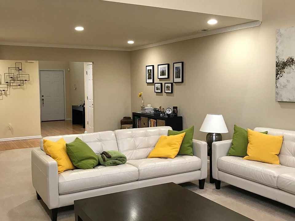 Living Room (16.6 x 22): Carpeted floors, two story windows,