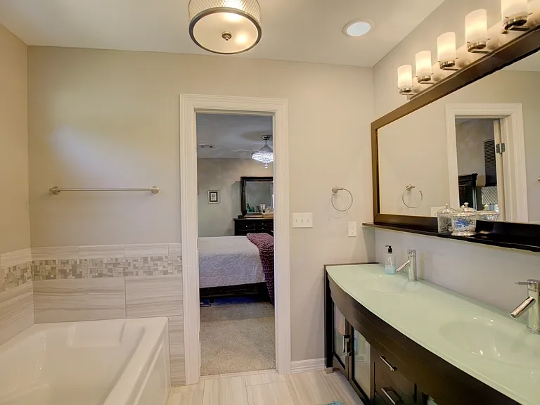 master bath with soaking tub and separate glass shower