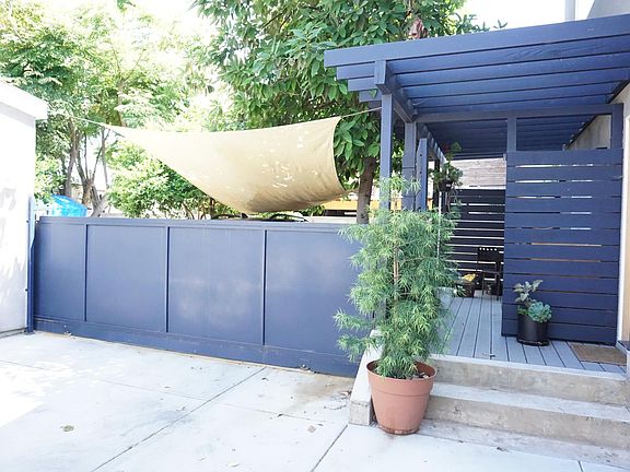 Rear unit w/ a gate to the parking space. Private first floor deck pictured