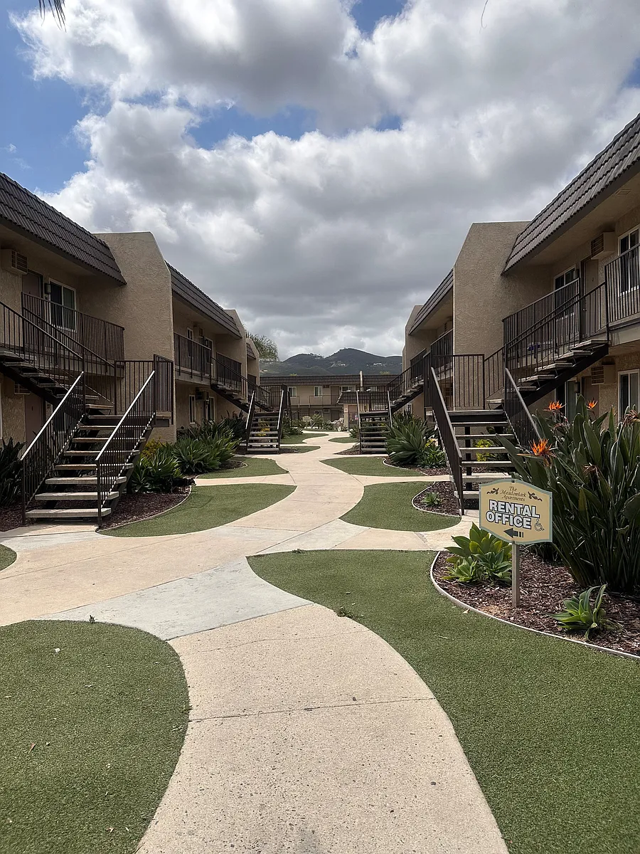 Walkway between buildings at The Meadowlark Apartments in San Marcos, CA. - The Meadowlark Apartments