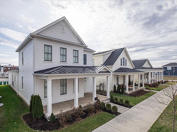 This stunning home has a large front porch along with an outdoor living space and fenced in yard