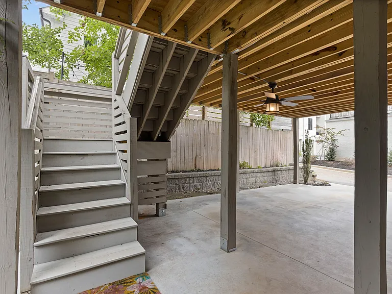 Carport parking with and EV charger plug. Upstairs is a separate private studio