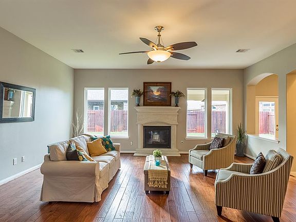 Lovely cast stone fireplace, seamless windows, room for a huge sectional too!
