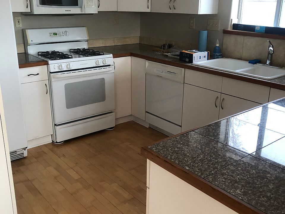 Kitchen. Gas range. Refrigerator and slate breakfast bar in other photo.