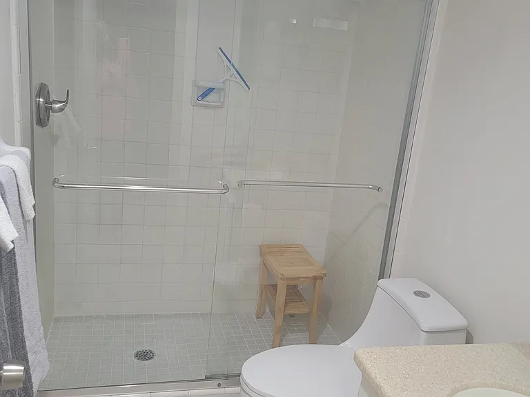 Master bedroom has a walk-in shower with shower bench.