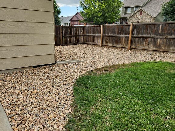 Backyard, side 
Freshly rocked