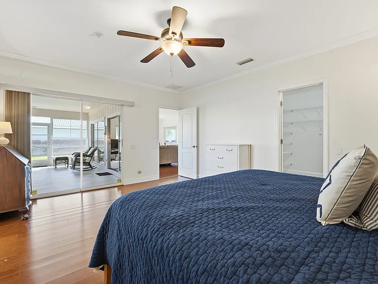 Primary bedroom with views of the lanai & large walk-in closet