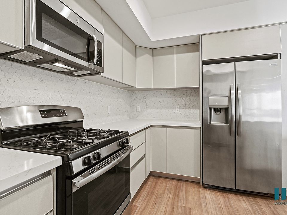 Kitchen with Stainless-Steel Refrigerator, Stove, and Microwave Oven