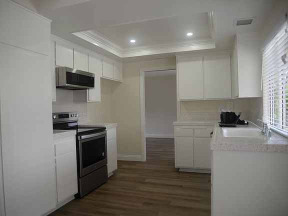 Kitchen with new stove, microwave and dishwasher