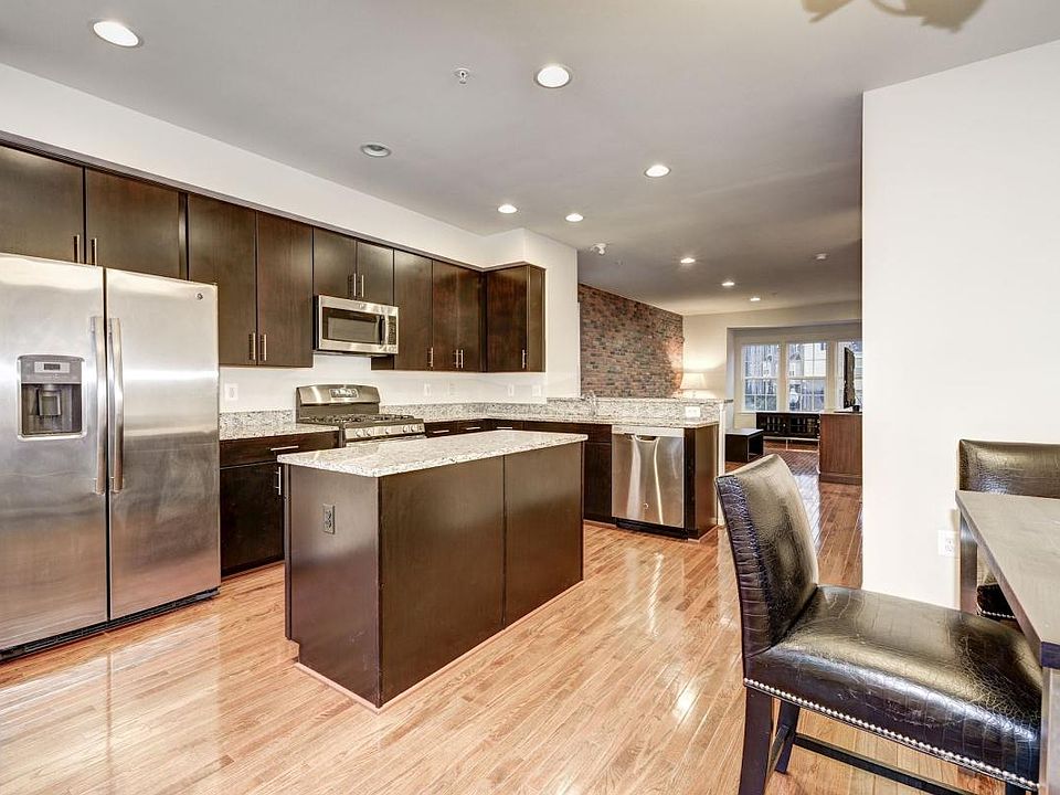 Modern kitchen, SS appliances, Brick wall...