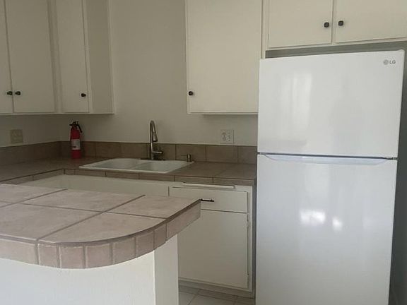 Kitchen with new fridge raider freezer ample cabinet space and countertop