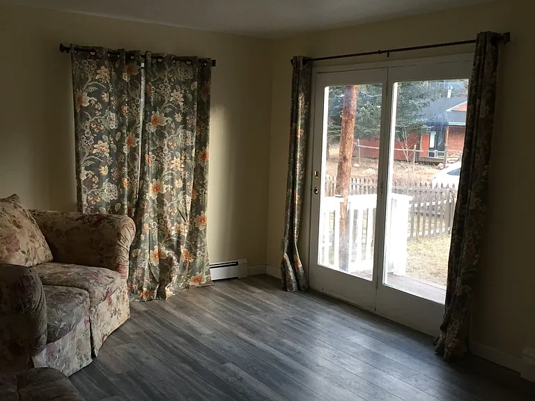 Lots of sunlight in the livingroom with large glass door out to the porch.