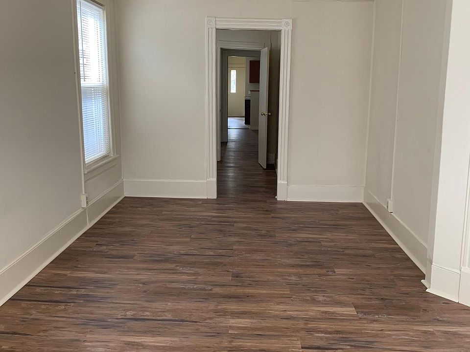 View from living room. Looking into hallway, bedroom, and kitchen.