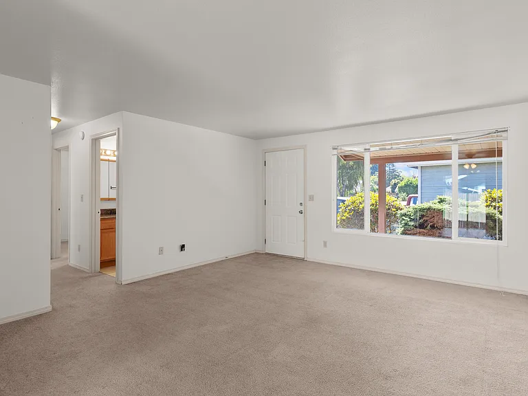 Another view of living room ( not staged) hallway leads to bathroom and 2 bedrooms