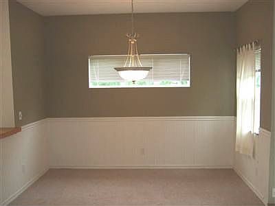 Dining room with a touch of elegance. Wainscoating and a nice overhead light.