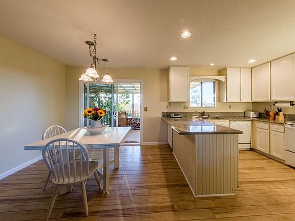 Kitchen leads to covered patio.