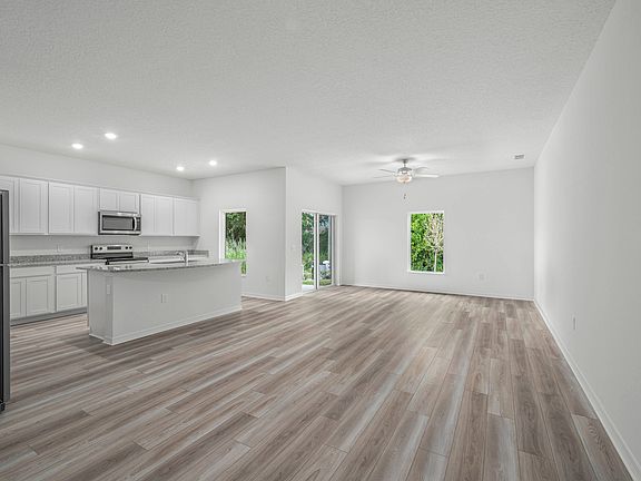 Vinyl flooring fills the main living areas